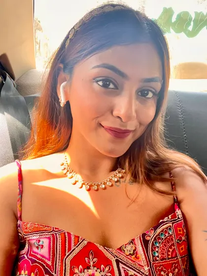 A car selfie on the way to a wedding. The pearl headband and necklace add a touch of elegance to my patterned sundress.