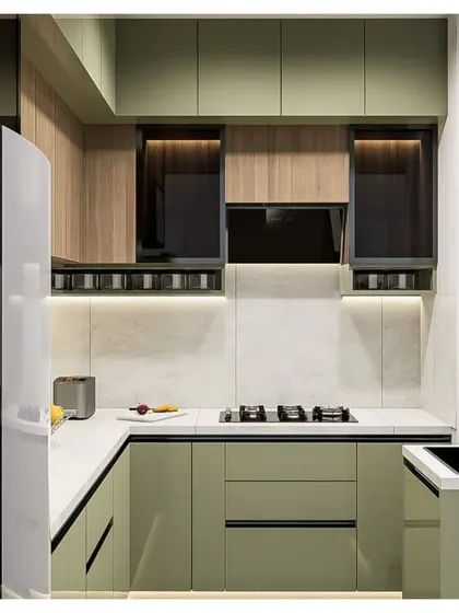 Another angle of the sage green and wood kitchen concept, focusing on the cooking area with the integrated hob and chimney.