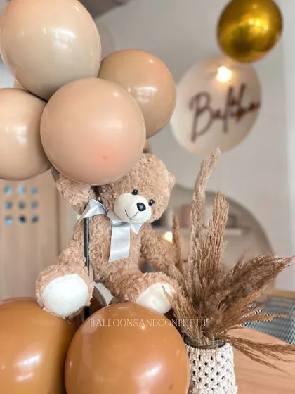These adorable teddy bear table centerpieces are perfect for a baby shower. The neutral, earthy tones are great for a boho or teddy-bear-themed celebration.