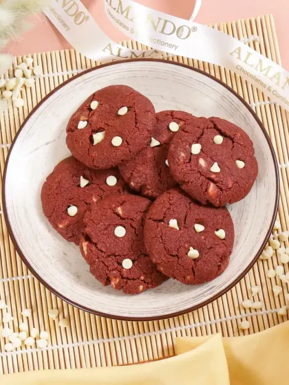 The deep red of these red velvet cookies pops against the light, neutral background. This shot focuses on the visual appeal of the cookies themselves, with the white chocolate chips providing a lovely contrast.