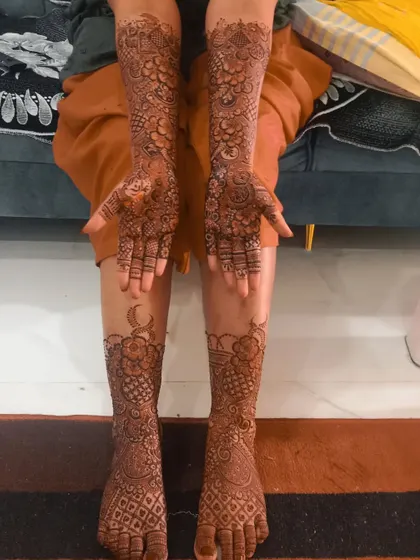 A complete bridal look with full coverage henna on both the hands and feet. The matching designs create a beautiful and harmonious look.