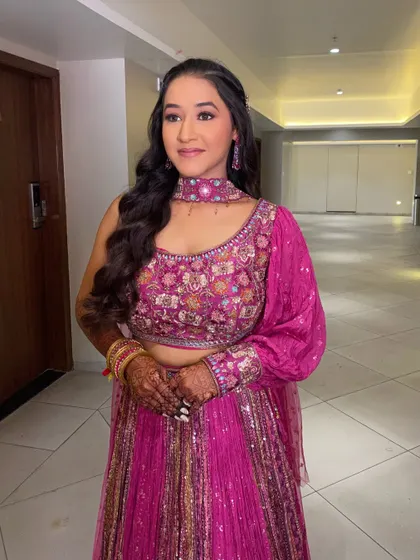 A beautiful look for a Myra function. The makeup is soft and pretty, with a pop of pink that coordinates perfectly with her vibrant fuchsia lehenga.