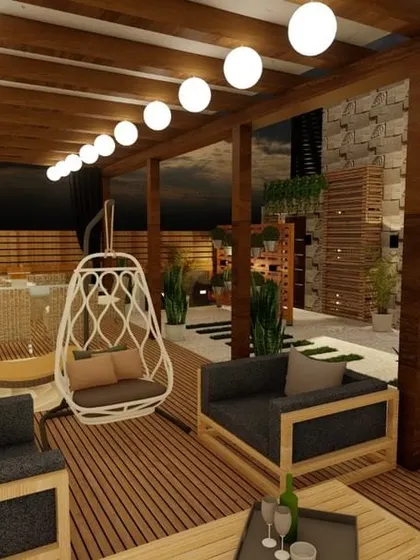 This expansive terrace is designed for large-scale entertaining. It features multiple seating zones, including sofas and egg swings, under a rustic wooden pergola with string lights, creating a resort-like atmosphere.
