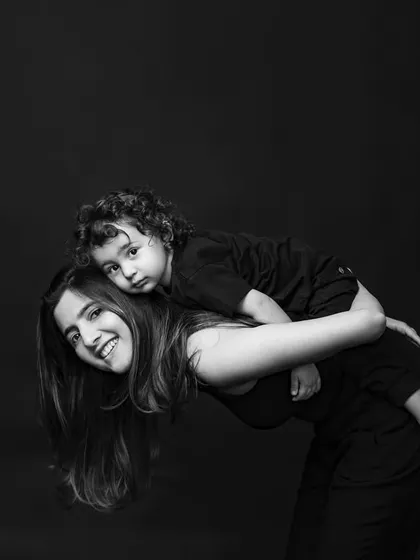 A piggyback ride from mom! This playful, candid moment is a perfect example of the fun we have during our Mom & Me mini sessions.