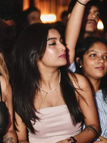 A guest enjoying the music, a serene moment amidst the high-energy party.