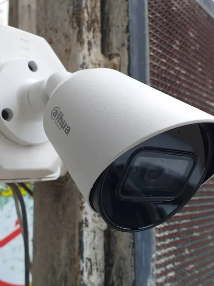 A Dahua bullet camera installed to monitor a storefront. The wide-angle lens and protective hood make it ideal for capturing activity in outdoor commercial environments.