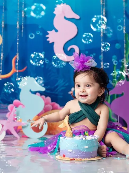 Under the sea! A magical mermaid-themed cake smash to celebrate a very special first birthday.