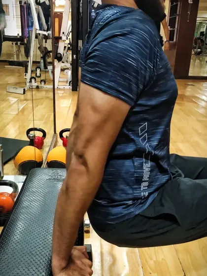 The result of consistent tricep work. This is my client's arm after just two weeks of focused training on dips and other exercises.