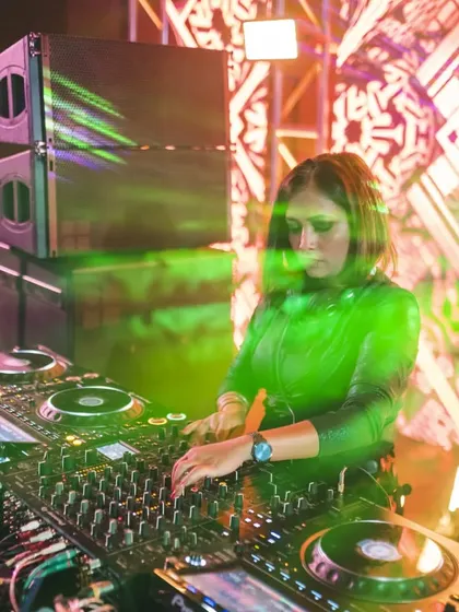 A great shot of me playing a sundowner set, with the stage lights blending with the evening sky. I love curating a journey that starts chill and builds up as the night begins.