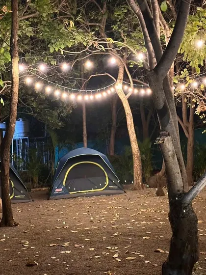 A closer look at our cozy, well-lit tent setup at night. It’s the perfect base for your team's adventure in Ananthagiri Hills.