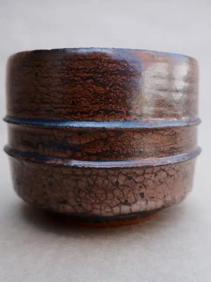 A classic earthenware tea bowl with a beautiful crackle glaze. The fine network of lines across the surface will darken over time with use, telling the story of many shared cups of tea.