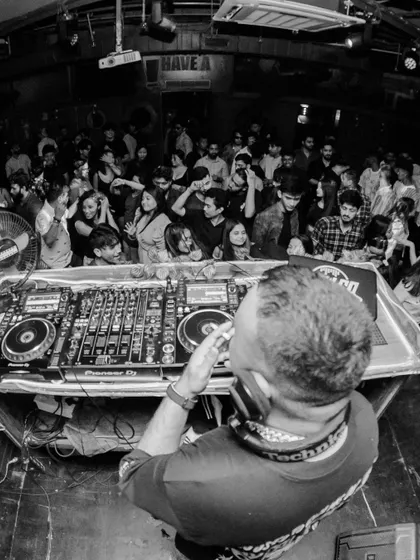 A fisheye lens shot from behind the console at Nuts & Brew. This perspective shows the packed crowd and the intimate connection I build with them.