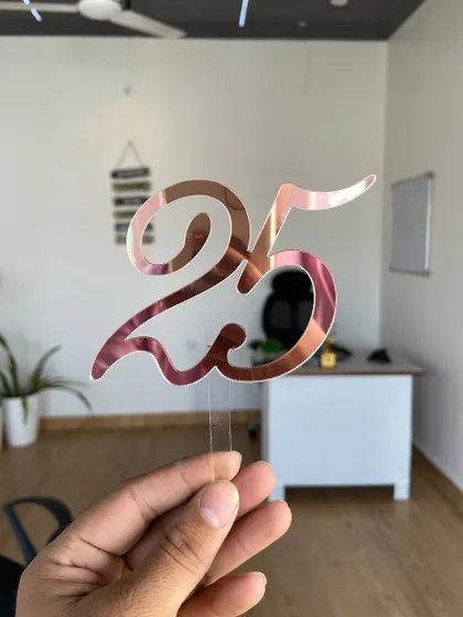 A simple yet elegant "25" topper in rose gold, perfect for a 25th birthday or anniversary celebration.