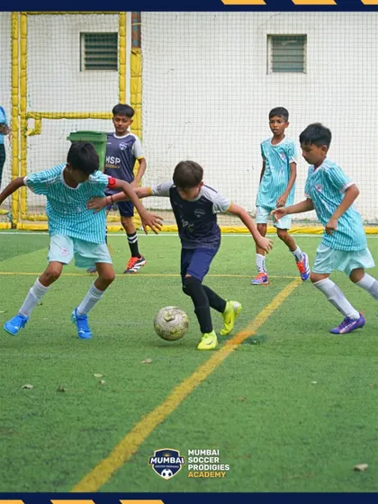 Players swarm the ball, demonstrating the high-energy, competitive environment of our academy.