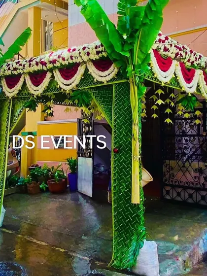 Another view of the traditional coconut leaf entrance, showing how it frames the doorway of a home. The fresh green leaves and flowers create a welcoming and festive feel for arriving guests.