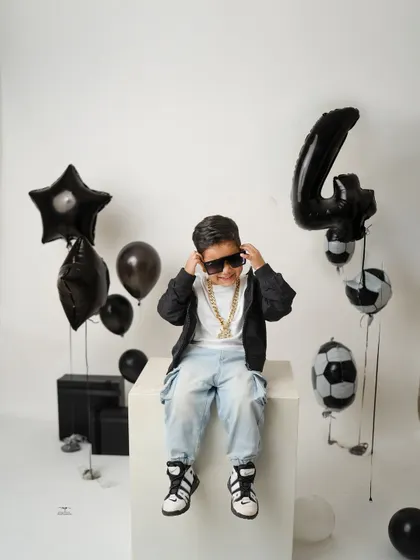 This little model is turning four with some serious style. With sunglasses and a cool pose, he's ready for his close-up in this football-themed birthday shoot.