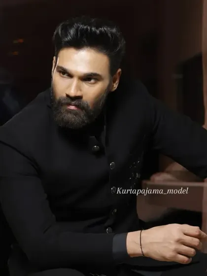 A powerful portrait shot of a client in the black Jodhpuri, highlighting its sharp collar and shoulder construction.