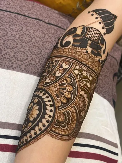 This full arm design incorporates the elephant motif at the top. You'll learn how to position figures effectively within a larger bridal piece.
