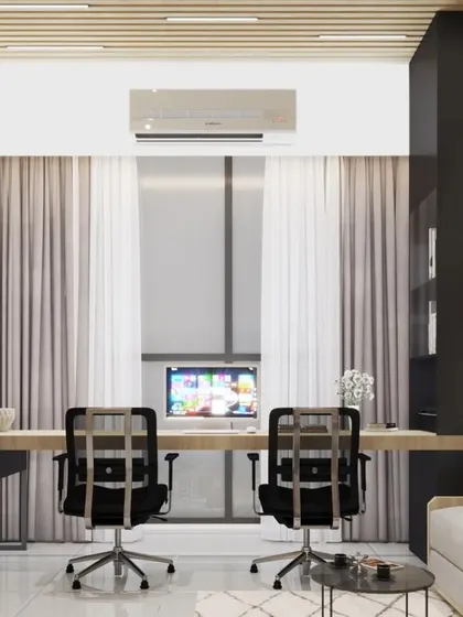 Another view of the home office, showing a long desk that accommodates two people comfortably, with a large window providing excellent natural light.