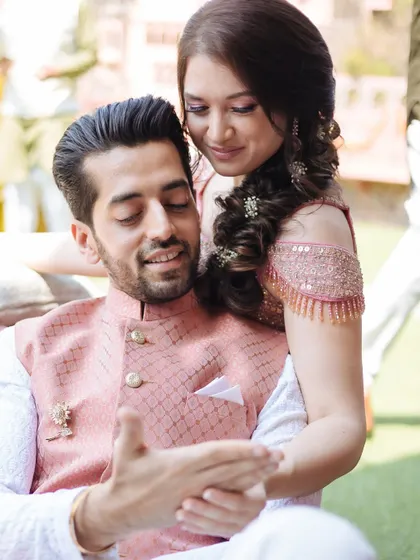 A sweet, candid moment between the bride and groom during their Mehendi at Fort Neemrana.