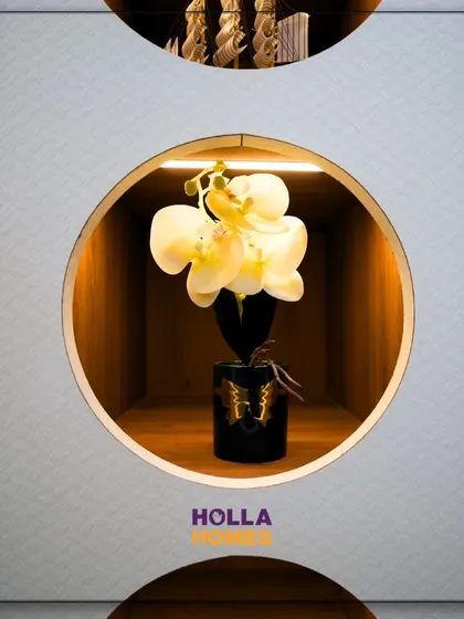 A close-up of the circular display niches in the kid's wardrobe, perfect for showcasing small decorative items and adding a unique design touch.