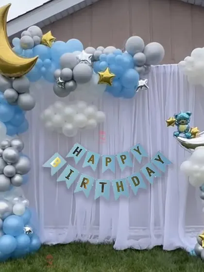 A dreamy "Twinkle Twinkle Little Star" theme with a moon and clouds. The blue, silver, and white balloons create a peaceful night-sky effect.