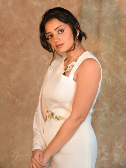 Styling Hruta Durgule in this elegant one-shoulder white gown. The design features a single flowing sleeve and intricate embellishments for a touch of contemporary glamour.