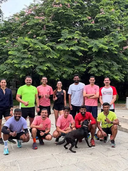 The team posing after a workout. The mix of bright-colored running gear shows the vibrant energy of our club.