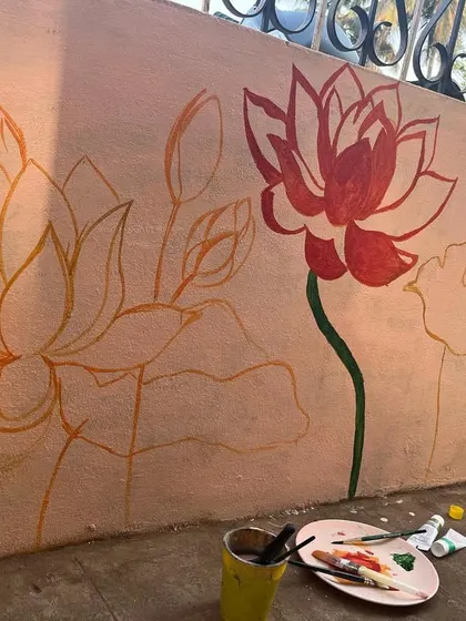 The first step in my process is often sketching the design directly onto the wall. Here you can see the initial outlines for the lotus mural, which set the foundation for the painting.