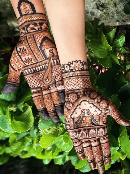 A unique design with one hand featuring a peacock and the other a doli, telling a story across both palms.