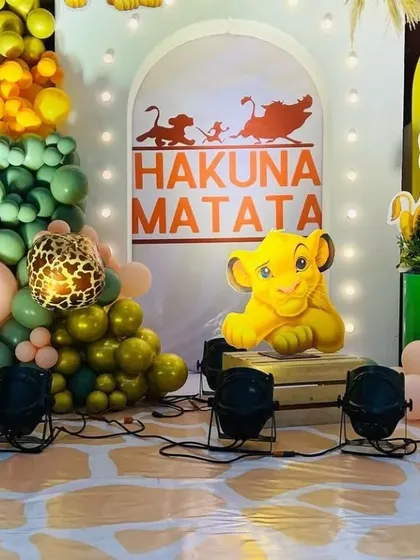 A close-up of the 'Hakuna Matata' setup. The use of animal print balloons and character cutouts against a yellow and green backdrop perfectly captures the spirit of The Lion King.