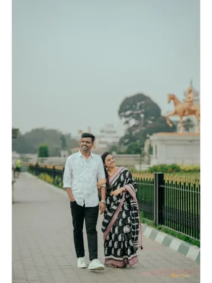 A couple enjoys a romantic stroll along a city path, capturing a simple yet beautiful moment of togetherness.