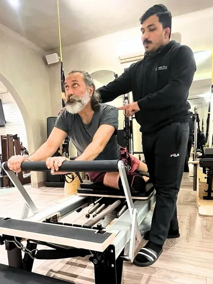 Our trainers have your back, literally. A private session allows for personalized adjustments to exercises like this back extension on the Reformer, ensuring spinal health.