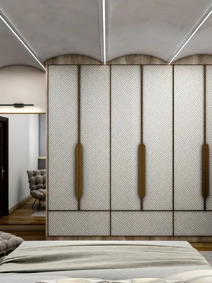 A bedroom featuring a full-height wardrobe with a unique textured fabric finish and long, minimalist wooden handles. The curved ceiling with integrated lighting adds a soft, architectural element to the room.