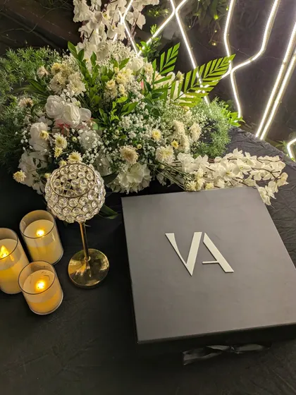 A close-up of our bespoke keepsake box, featuring the couple's initials. We believe every detail matters, and our custom packaging ensures your Forever Book is protected in style.