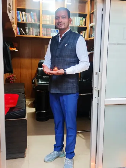 Holding a diya at the doorway of the Lawyer Mitra office. A symbol of hope and prosperity.