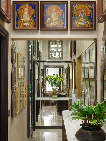 A long corridor in the Courtyard Home is treated as a picture gallery, with judiciously placed mirrors enhancing the depth and sense of space. The collection of art and objects tells a story as you walk through.