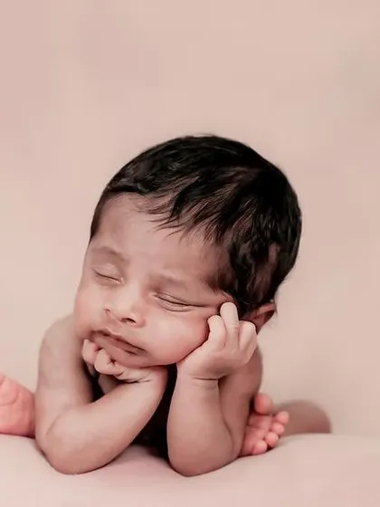 A beautiful, color-toned photo of a sleeping newborn. We use soft fabrics and gentle posing to keep your baby comfortable and safe.