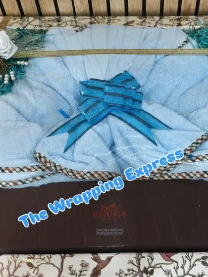 A luxury bathrobe and perfumed soap set, packed neatly in a tray. This makes for a very thoughtful and useful gift for the groom.