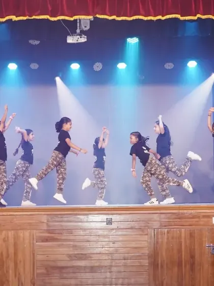 A wide shot of the kids' hip hop routine, showing their impressive synchronization and stage presence.