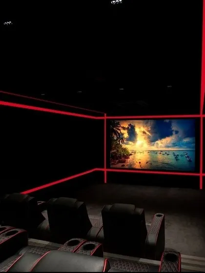 A minimalist yet striking home theater design using bold red LED light strips to outline the room. This technique creates a futuristic and fully immersive environment, drawing all focus to the crystal-clear picture on screen.