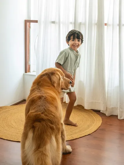 A genuine smile from a boy playing with his dog. My sessions are about creating a fun environment where even camera-shy kids can relax and be themselves.