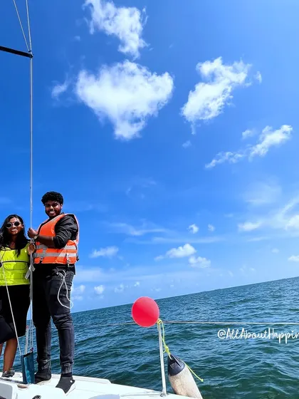 A wide shot of the happy couple on the yacht, with a heart-shaped cloud seemingly appearing just for them. It was a truly magical day.