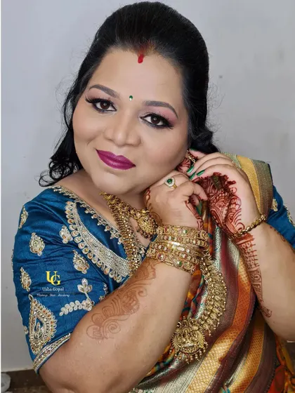 My client Chitra, getting ready for her son's birthday party. This candid shot captures the final touches of her glamorous traditional look.