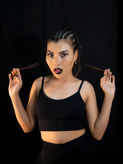 This playful pose shows off the full effect of the catwalk look, including the cornrow braids and bold makeup. We teach students how to create looks that are dynamic from every angle.