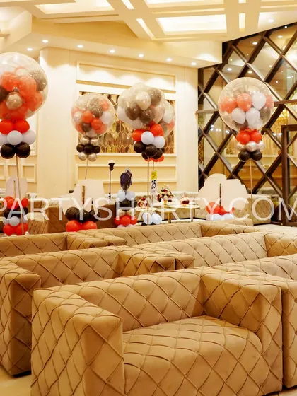 A wide shot of the lounge seating at a car-themed party, with themed balloon centerpieces creating a cohesive look throughout the space.