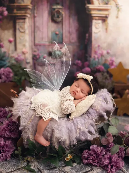 Another angle of the magical fairy photoshoot, with the newborn sleeping peacefully on a fluffy purple cloud.