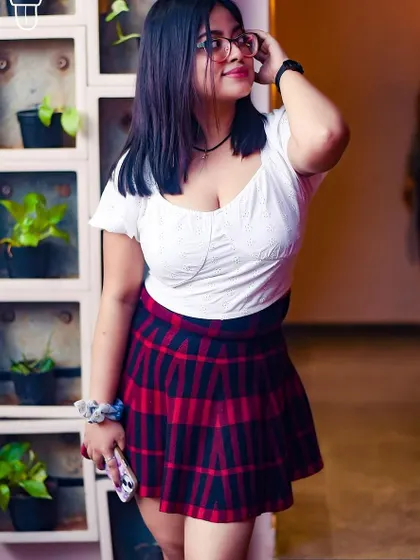 A guest in a classic plaid skirt, enjoying the youthful energy of the party.