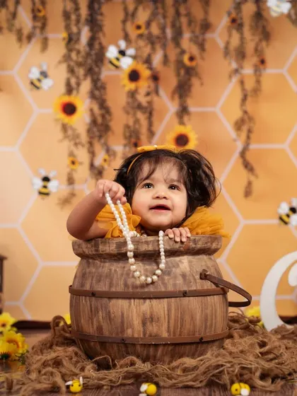 Our honeybee theme is buzzing with cuteness! This little one is peeking out of a honey pot.