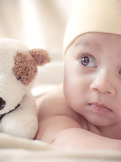 An alert newborn enjoying some tummy time with a stuffed animal friend. I capture both sleepy and awake moments to show your baby's budding personality.